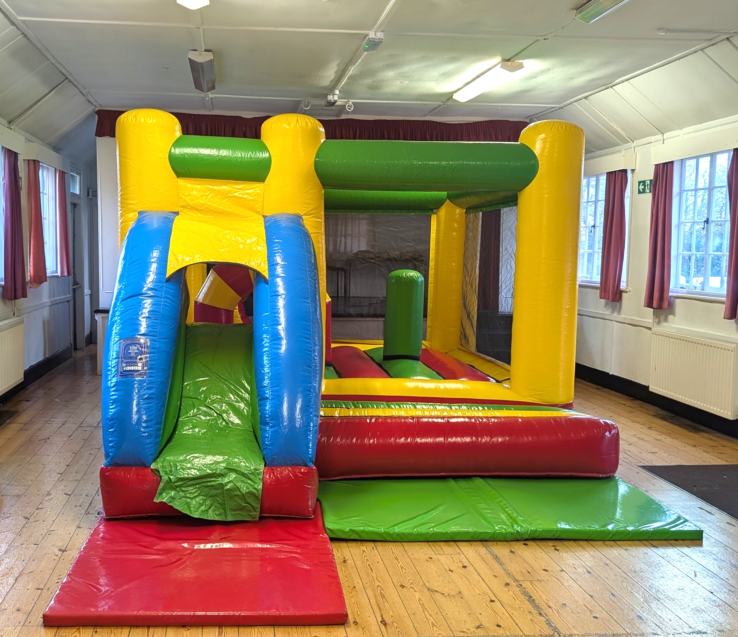 Multicolour Bouncy Castle with Slide indoor bouncy castle hire in village hall Essex